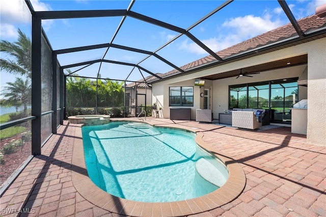 view of swimming pool featuring a patio, a pool with connected hot tub, an outdoor hangout area, glass enclosure, and ceiling fan