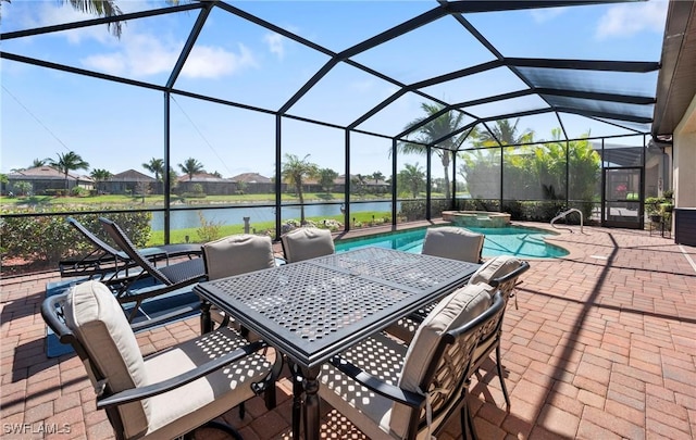 view of patio / terrace with a water view, glass enclosure, and a pool with connected hot tub