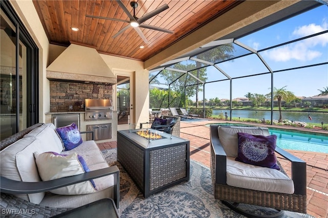 view of patio / terrace with an outdoor living space with a fire pit, a water view, and area for grilling