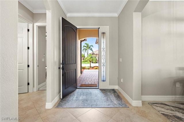 entryway featuring ornamental molding, light tile patterned flooring, and baseboards