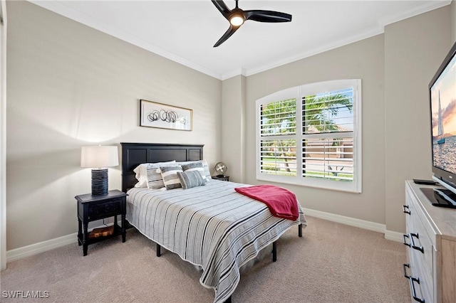 bedroom featuring light carpet, ceiling fan, baseboards, and crown molding