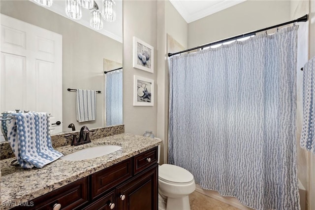 bathroom with ornamental molding, vanity, toilet, and tile patterned floors