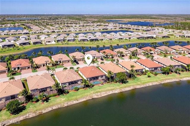 drone / aerial view featuring a water view and a residential view