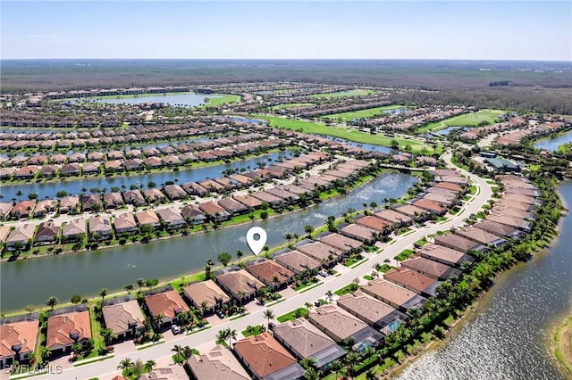 drone / aerial view with a water view and a residential view