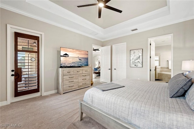 bedroom featuring ornamental molding, a tray ceiling, visible vents, and light colored carpet