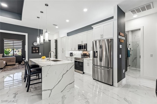 kitchen with marble finish floor, visible vents, stainless steel appliances, and a sink