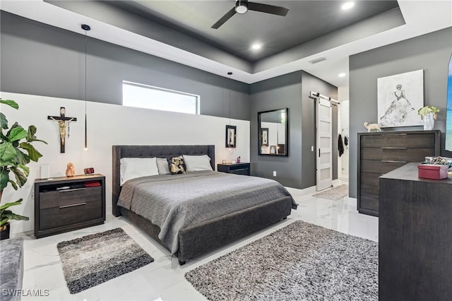 bedroom with marble finish floor, recessed lighting, a raised ceiling, visible vents, and a barn door