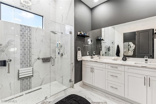 bathroom with marble finish floor, double vanity, a sink, and a marble finish shower