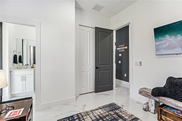 interior space with marble finish floor, visible vents, and baseboards