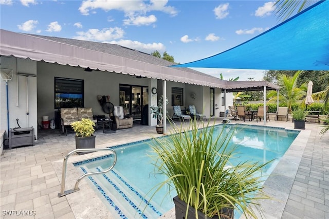 outdoor pool featuring outdoor lounge area and a patio