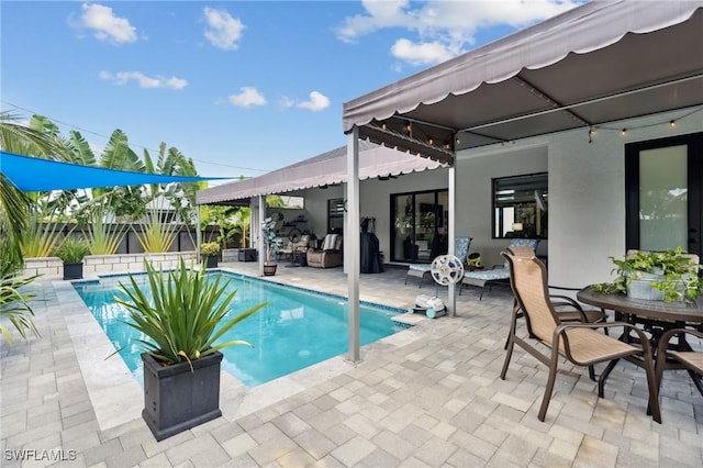 view of swimming pool featuring a patio area, fence, outdoor dining area, and a fenced in pool