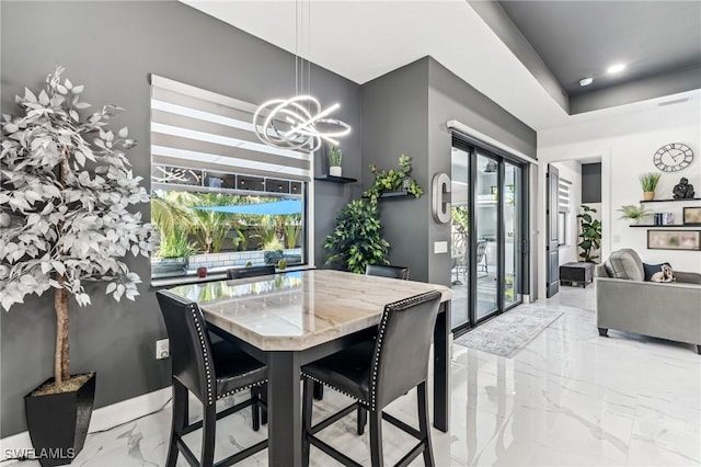 dining area with a healthy amount of sunlight, marble finish floor, visible vents, and a chandelier