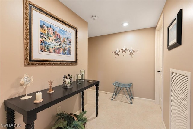 hallway with light tile patterned floors, visible vents, recessed lighting, and baseboards