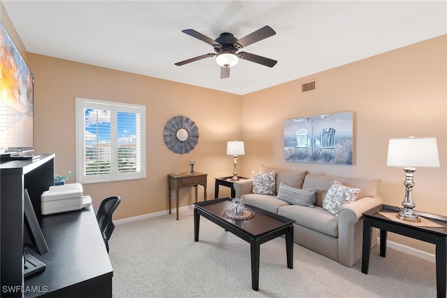 living area featuring a ceiling fan, light colored carpet, visible vents, and baseboards