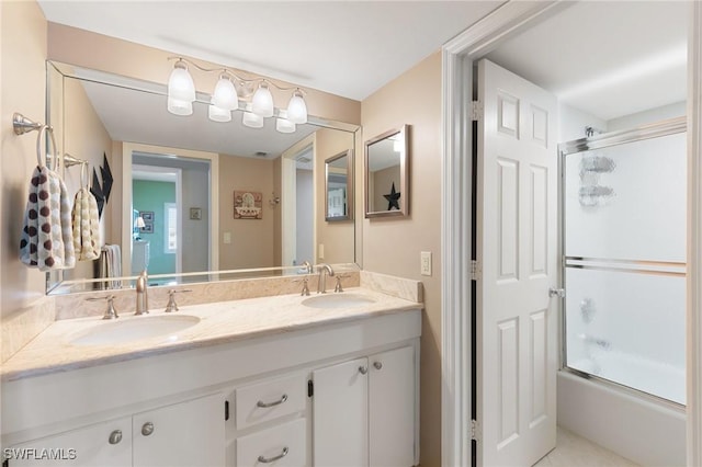 full bath with double vanity, combined bath / shower with glass door, and a sink