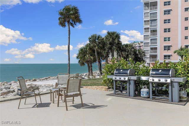 view of patio / terrace with a water view and grilling area