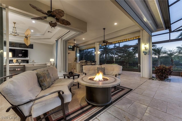 interior space with ceiling fan, a tray ceiling, and recessed lighting