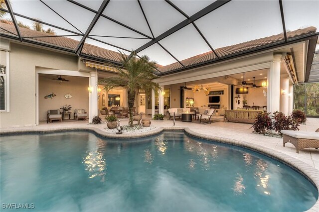 outdoor pool featuring a lanai, a patio area, outdoor lounge area, and a ceiling fan