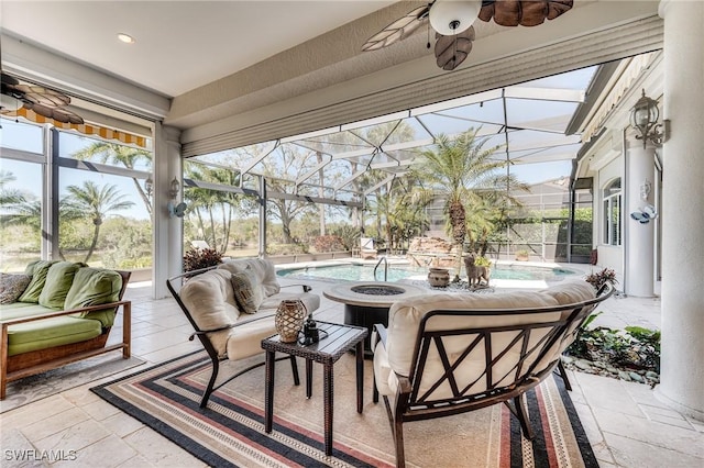 sunroom featuring a ceiling fan and plenty of natural light