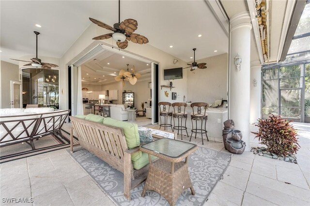 interior space featuring a lanai, ceiling fan, and an outdoor hangout area