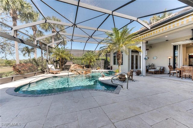 pool with a ceiling fan, french doors, glass enclosure, and a patio