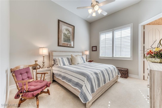 bedroom featuring light carpet, ceiling fan, and baseboards