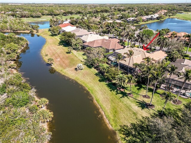 birds eye view of property with a water view and a residential view