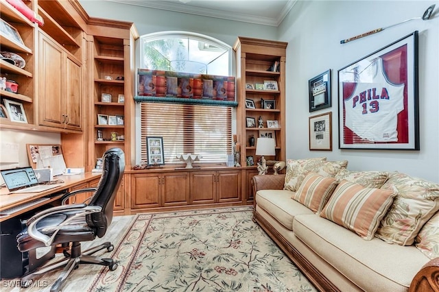 home office featuring crown molding and built in desk