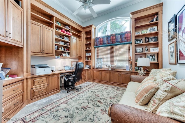 office area featuring ornamental molding, ceiling fan, and built in desk