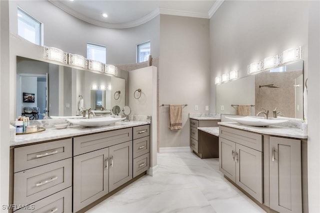 full bath with marble finish floor, two vanities, a sink, and crown molding