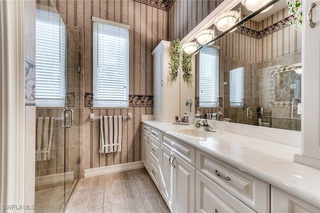 full bathroom with tile patterned flooring, a shower stall, and vanity