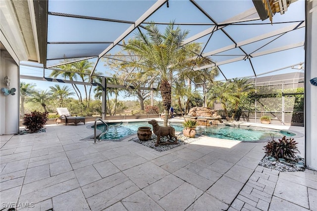 pool featuring a patio, glass enclosure, and an outdoor hot tub