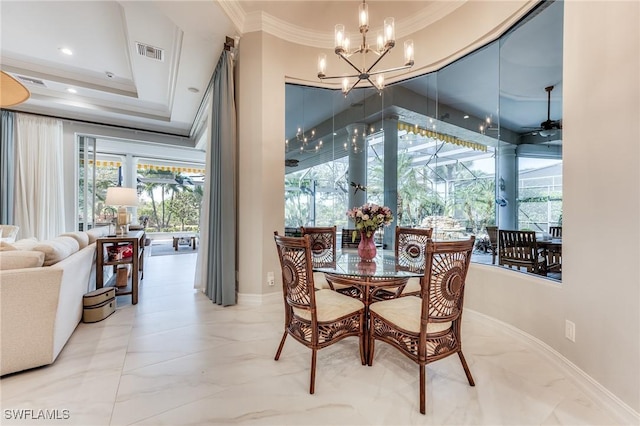 dining space featuring baseboards, visible vents, and crown molding