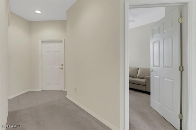 corridor with tile patterned flooring, carpet flooring, recessed lighting, and baseboards