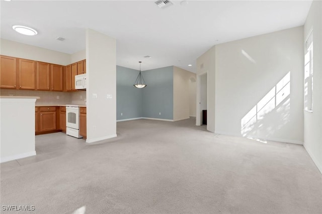 unfurnished living room with baseboards, visible vents, and light carpet