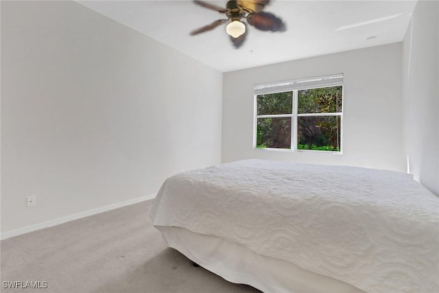 unfurnished bedroom featuring carpet flooring, a ceiling fan, and baseboards