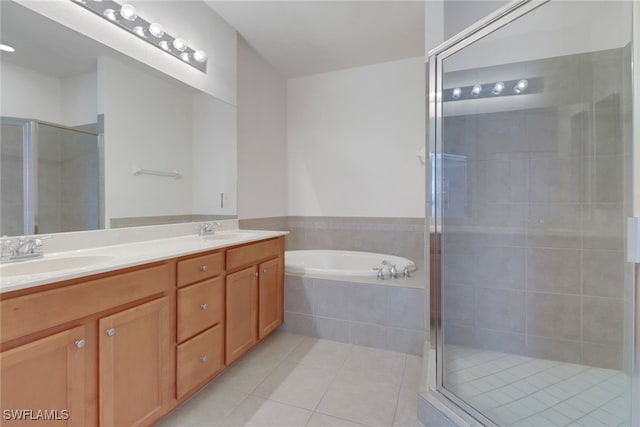 full bath featuring a sink, a shower stall, and tile patterned floors