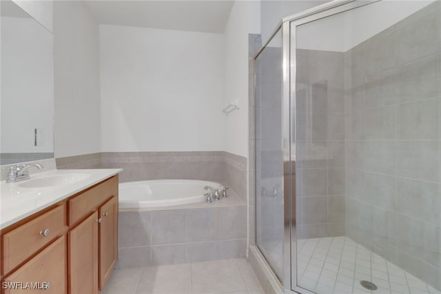 full bath featuring vanity, tile patterned floors, and a stall shower