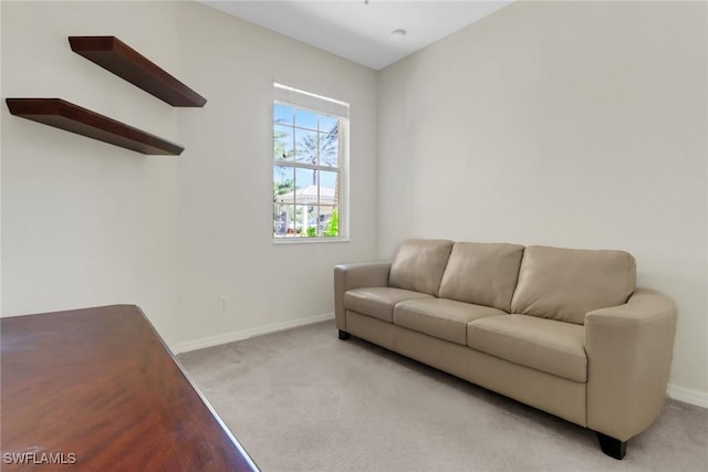 carpeted living room featuring baseboards