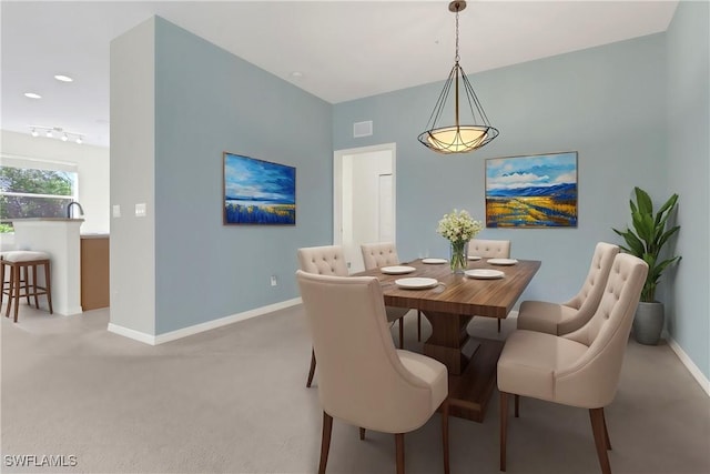 dining area with visible vents, baseboards, and carpet floors