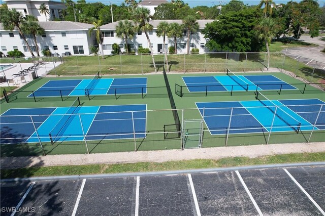 view of sport court featuring fence and a residential view