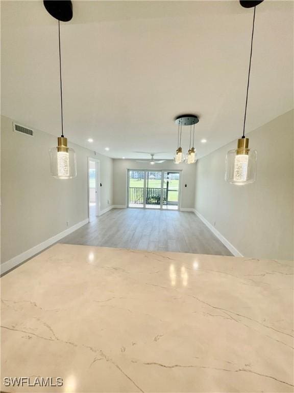 unfurnished living room with baseboards, visible vents, a ceiling fan, and recessed lighting