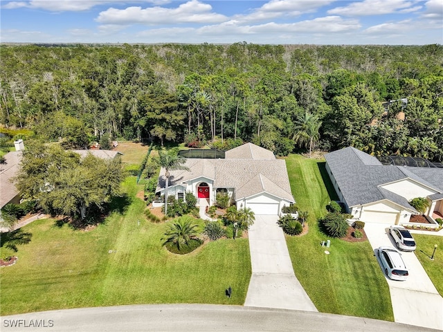 drone / aerial view featuring a wooded view