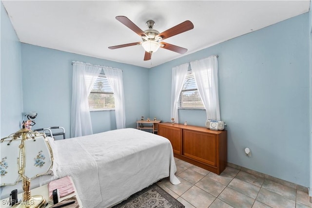 bedroom with ceiling fan and light tile patterned flooring