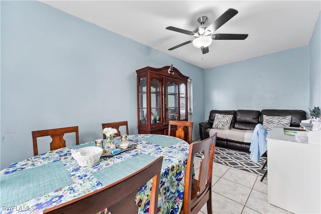 dining area with light tile patterned floors and a ceiling fan