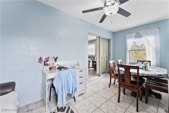 dining room with a ceiling fan and light tile patterned floors