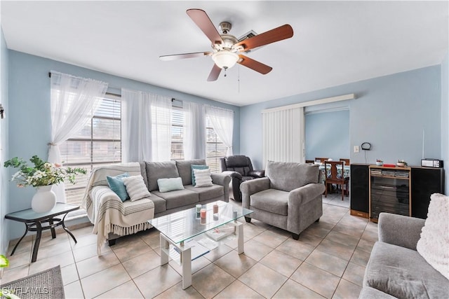 living room with beverage cooler, ceiling fan, and light tile patterned floors