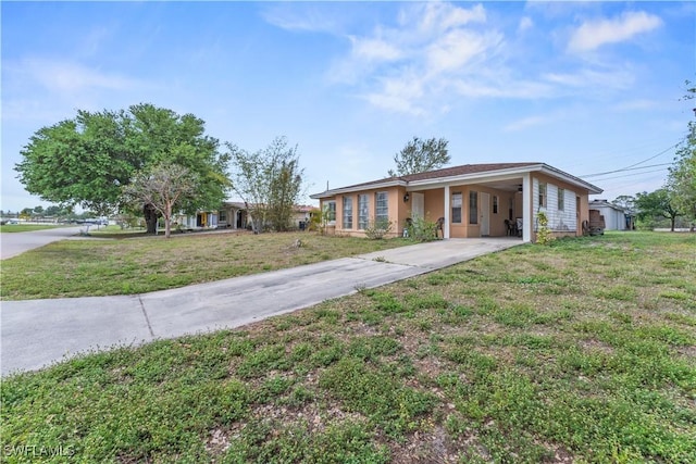 ranch-style house with a carport, concrete driveway, and a front lawn