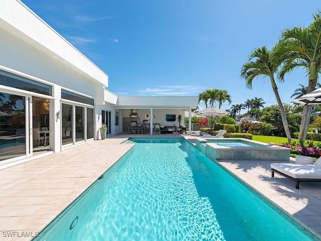 view of swimming pool featuring a patio and a pool with connected hot tub