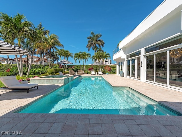 view of swimming pool featuring a patio area and a pool with connected hot tub